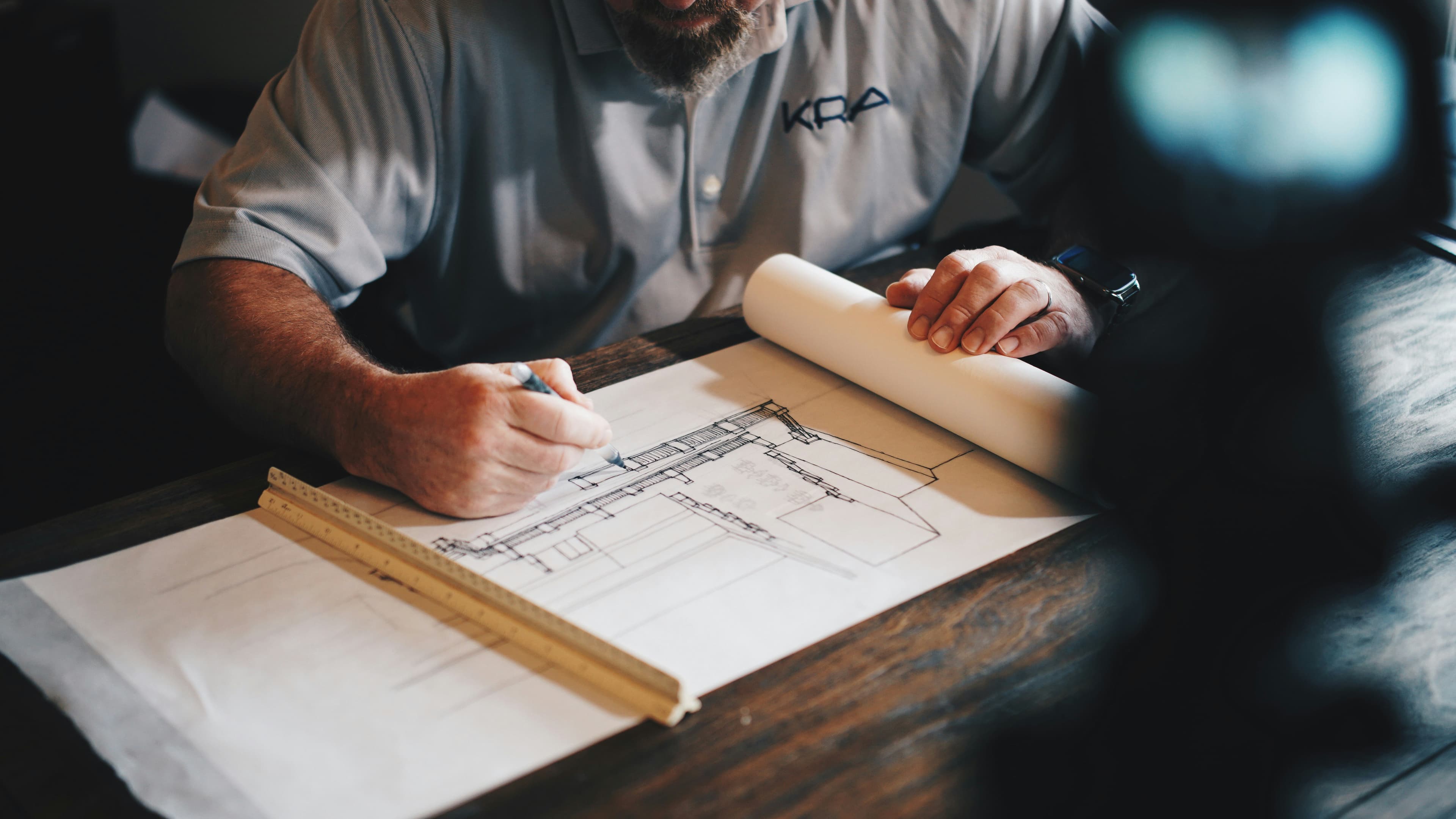 Construction team reviewing project workflow plans at a jobsite table.
